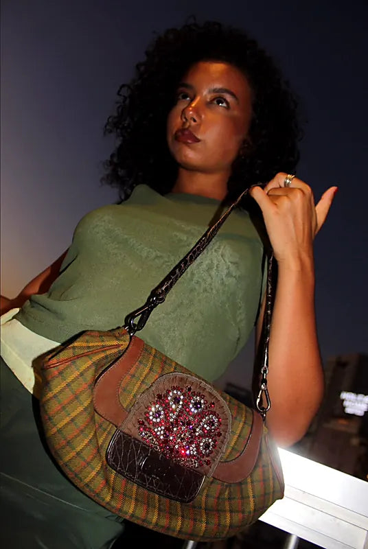 Night portrait with the crystal-embellished tartan bag held on a crocodile-embossed strap